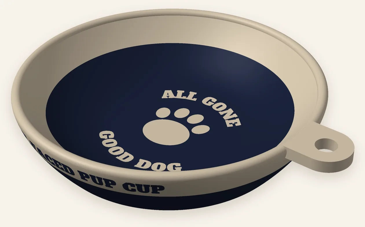 3D preview of the flat-faced pup cup: a shallow, wide cup with a navy inside and lower half, a beige rim, the words All gone and Good dog around a paw on the floor, and a hang tab on one side.
